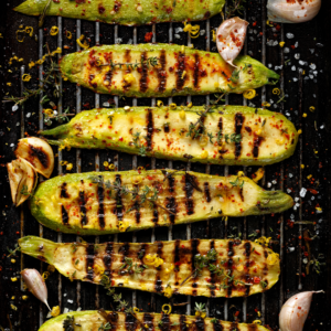 Sliced zucchini with seasoning on the bbq grill. 