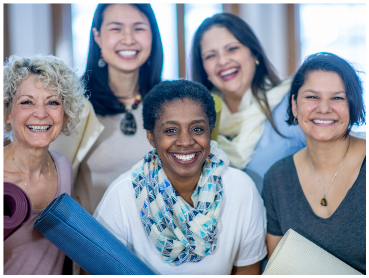 Women smiling at camera after yoga class